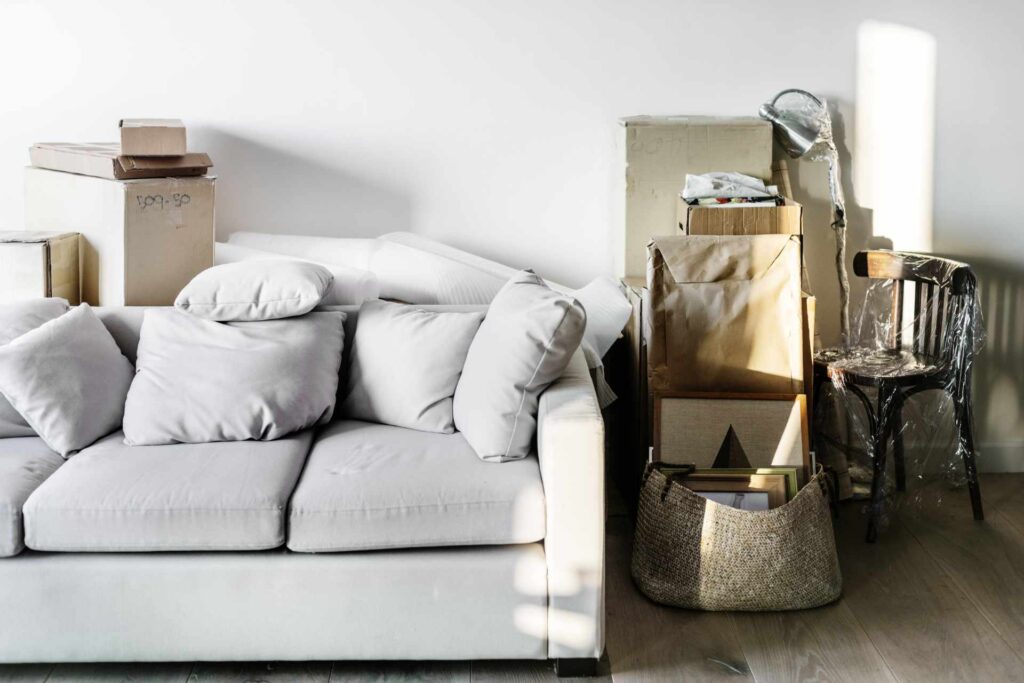 Couch mit verpackten Bildern – Vorbereitung auf Haushaltsauflösung