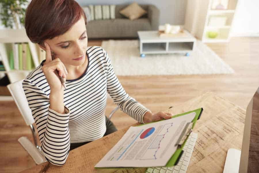 Frau analysiert Energieausweis und Energiedaten am Schreibtisch